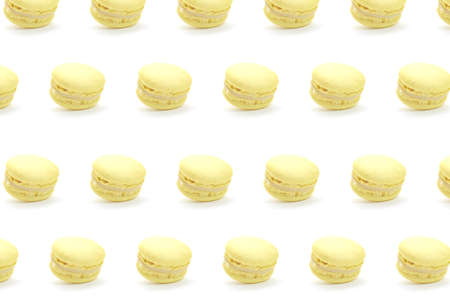 Yellow french macaroons isolated on white background. Nice pattern for your projects.の写真素材