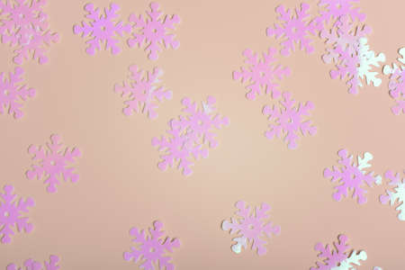 Holographic shiny snowflake sparkles on pink background.の写真素材