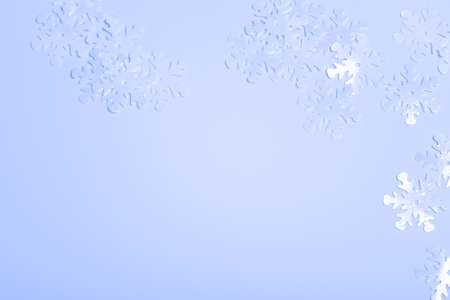 Shiny snowflake sparkles on blue colored background.の写真素材