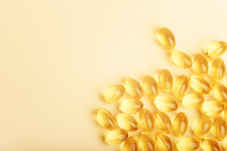 Omega 3 fish oil capsules on the colored background.の写真素材