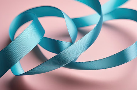Curved pastel colored satin silk ribbon on colored background. Closeup.の写真素材