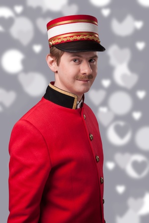 Portrait of a concierge  porter  in a red jacketの写真素材