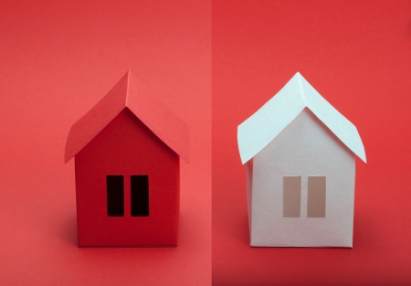White and red paper houses on red background の写真素材