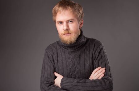 portrait ginger bearded man in jersey against gray backgroundの写真素材
