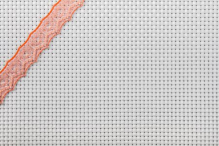 white canvas for the embroidery a cross framed by a lace tapeの写真素材