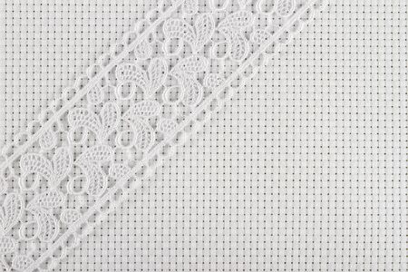 canvas for the embroidery a cross framed by a lace tapeの写真素材