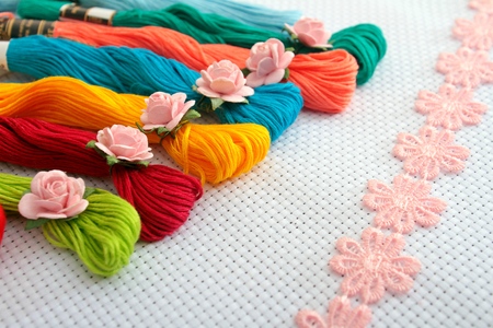 Muline roses decorated with flowers, lace ribbon, lay on the canvas