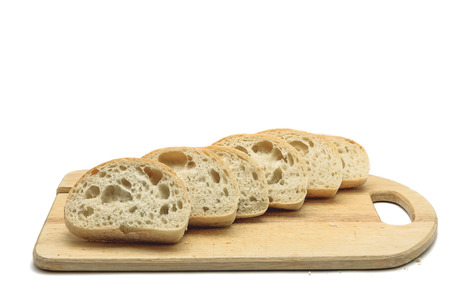 cut ciabatta lies on carving board isolated on white background