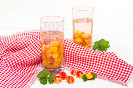 Useful compote of cloudberries on the table
