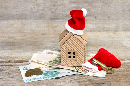 House, money and key with Christmas trappings. Holiday discountsの写真素材