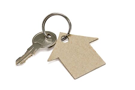 House made of cardboard and key on white backgroundの写真素材