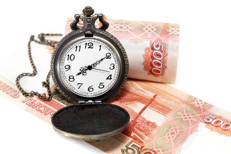 Time is money. Clock and money on a white backgroundの写真素材