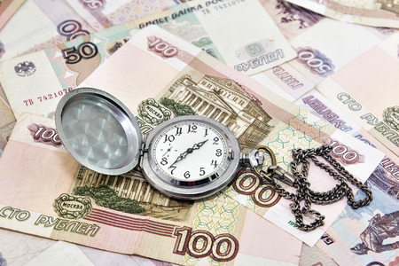 Pocket watch against the background of Russian money. Time to pay taxesの写真素材
