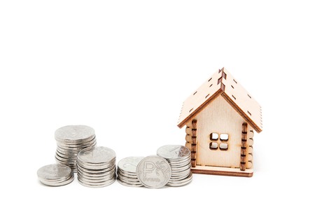 Wooden house and Russian coins on a white backgroundの写真素材