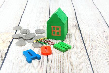 Paper green house and money.