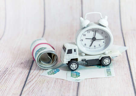 Children's car, money and watch. Compliance with commercial cargo transportation lawsの写真素材