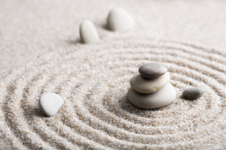 Japanese zen garden meditation stone for concentration and relaxation sand and rock for harmony and balance in pure simplicity - macro lens shotの写真素材