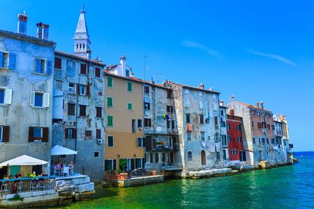 Wonderful romantic old town at Adriatic sea. Old houses in the harbor azure-turquoise crystal-clear water at magical summer. Blurred-unrecognizable faces. Rovinj. Istria. Croatia. Europe.の写真素材