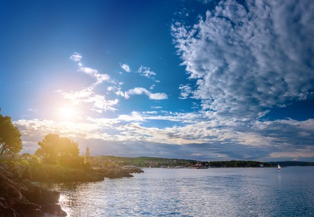 Wonderful romantic summer evening landscape panorama coastline Adriatic sea. Boats and yachts in harbor at cristal clear azure water. Old town of Krk on the island of Krk. Croatia. Europe.の写真素材