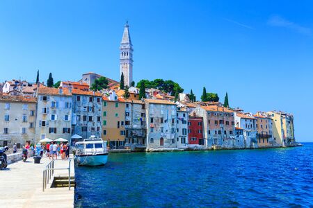 Wonderful romantic old town at Adriatic sea. Old houses in the harbor azure-turquoise crystal-clear water at magical summer. Blurred-unrecognizable faces. Rovinj. Istria. Croatia. Europe.の写真素材