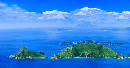 Beautiful summertime panoramic seascape. View of the cliff into the crystal clear azure sea bay and distant islands. Agios Stefanos cape. Afionas. Corfu. Greece.の写真素材