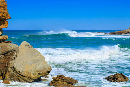 A huge waves on the ocean coast in a shine bright light  at sunny day. Wonderful romantic seascape of ocean coastline.の写真素材