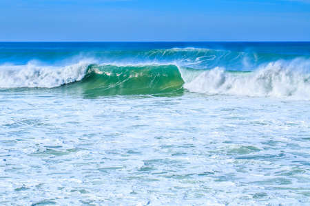 A huge waves on the ocean coast in a shine bright light  at sunny day. Wonderful romantic seascape...