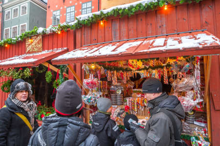 STOCKHOLM, SWEDEN - NOV 26: Christmas atmosphere of the city. People rest, have fun and shoping on Christmas Fair on Stortorget, Hamla Stan. Stockholm. Sweden. Europe. November 26, 2010のeditorial素材