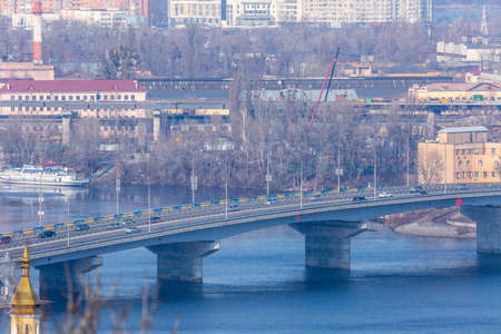 Early spring at sunny evening in warm weather. Industrial zone and residential areas Podin and northern suburbs Obolon in Kyiv on the right bank of the Dnipro River. Ukraine Mar. 6, 2019のeditorial素材
