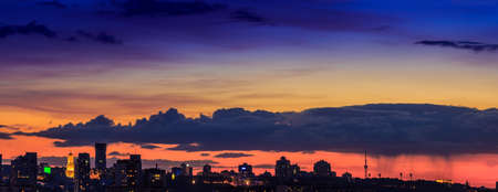 Panoramic view of the big city silhouette against the backdrop of incredibly, awesome bright, multicolour sunset. Kyiv. Ukraine.の写真素材