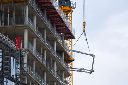 Crane hoisting block with hook on steel chain on the steel rope lift the huge steel beams....