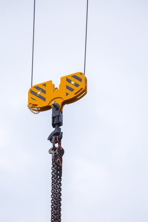 Crane hoisting block with hook on steel chain on the steel rope. Loading\unloading of building...