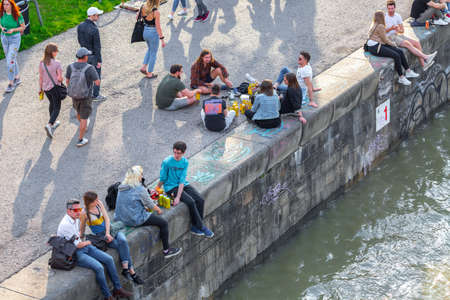 VIENNA, AUSTRIA - MAY 25: Many people are relaxing with alcohol drinks on a day off in a beautiful summer weather on the banks of the Danube Canal(Donaukanal) in Vienna, Austria, on May 25, 2019.のeditorial素材