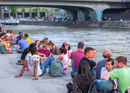 VIENNA, AUSTRIA - MAY 25: Many people are relaxing with alcohol drinks on a day off in a beautiful summer weather on the banks of the Danube Canal(Donaukanal) in Vienna, Austria, on May 25, 2019.のeditorial素材