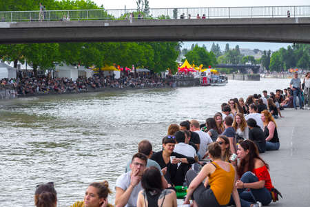 VIENNA, AUSTRIA - MAY 25: Many people are relaxing with alcohol drinks on a day off in a beautiful summer weather on the banks of the Danube Canal(Donaukanal) in Vienna, Austria, on May 25, 2019.のeditorial素材