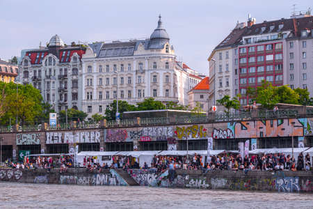 VIENNA, AUSTRIA - MAY 25: Many people are relaxing with alcohol drinks on a day off in a beautiful...