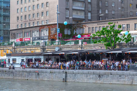 VIENNA, AUSTRIA - MAY 25: Many people are relaxing with alcohol drinks on a day off in a beautiful summer weather on the banks of the Danube Canal(Donaukanal) in Vienna, Austria, on May 25, 2019.のeditorial素材