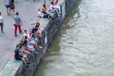 VIENNA, AUSTRIA - MAY 25: Many people are relaxing with alcohol drinks on a day off in a beautiful summer weather on the banks of the Danube Canal(Donaukanal) in Vienna, Austria, on May 25, 2019.のeditorial素材