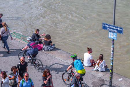 VIENNA, AUSTRIA - MAY 25: Many people are relaxing with alcohol drinks on a day off in a beautiful summer weather on the banks of the Danube Canal(Donaukanal) in Vienna, Austria, on May 25, 2019.のeditorial素材