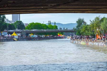 VIENNA, AUSTRIA - MAY 25: Many people are relaxing with alcohol drinks on a day off in a beautiful summer weather on the banks of the Danube Canal(Donaukanal) in Vienna, Austria, on May 25, 2019.のeditorial素材