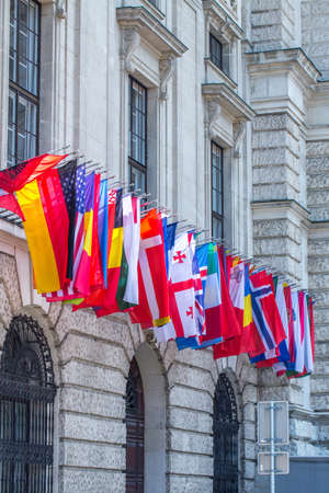 Flags of almost all countries of the northern hemisphere on the facade the building of Hofburg...