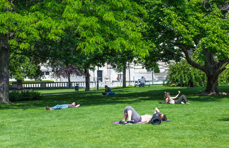 VIENNA, AUSTRIA - MAY 26: People are resting and relaxing in popular public Burggarten park in warm sunny day in Vienna, Austria, on May 26, 2019.のeditorial素材