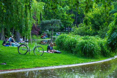 VIENNA, AUSTRIA - MAY 26: People are resting and relaxing in public Stadtpark park in warm sunny day in Vienna, Austria, on May 26, 2019.のeditorial素材