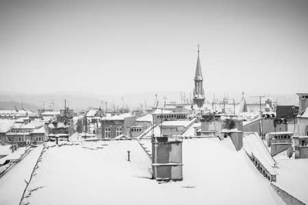 Krakow in Christmas time, aerial view on snowy roofs in central part of city. BW photo. Poland....