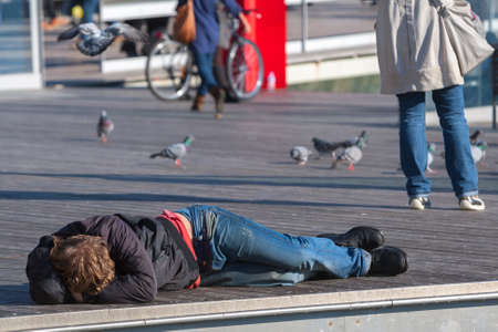 Spain, Barcelona - Jan 01, 2012: People Local and tourists have are rest and relaxing and walk in a leisurely way in a beautiful sunshine warm weather on a seafront Rambla De Mar near Maremagnum mall.のeditorial素材