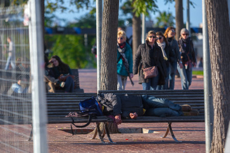 Spain, Barcelona - Jan 01, 2012: People Local and tourists have are rest and relaxing and walk in a leisurely way in a beautiful sunshine warm weather on a seafront Rambla De Mar near Maremagnum mall.のeditorial素材