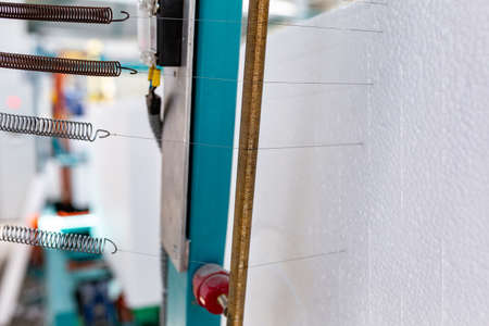 Industrial production of polystyrene foam insulation panels or plates. A large blocks of  foam is...