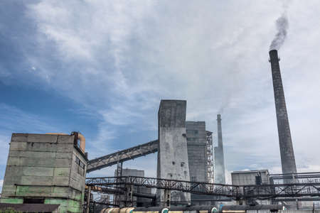 The largest air pollutant in city Dnipro Ukraine is coke-chemical plant. Flue gas stacks emit hundreds tons of harmful substances a years into the atmosphere. Industrial landscape.の写真素材