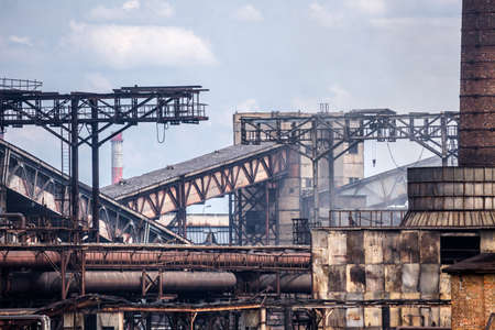 The largest air pollutant in city Dnipro Ukraine is coke-chemical plant. Flue gas stacks emit hundreds tons of harmful substances a years into the atmosphere. Industrial landscape.の写真素材