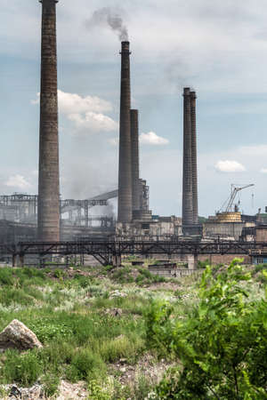 The largest air pollutant in city Dnipro Ukraine is coke-chemical plant. Flue gas stacks emit hundreds tons of harmful substances a years into the atmosphere. Industrial landscape.の写真素材
